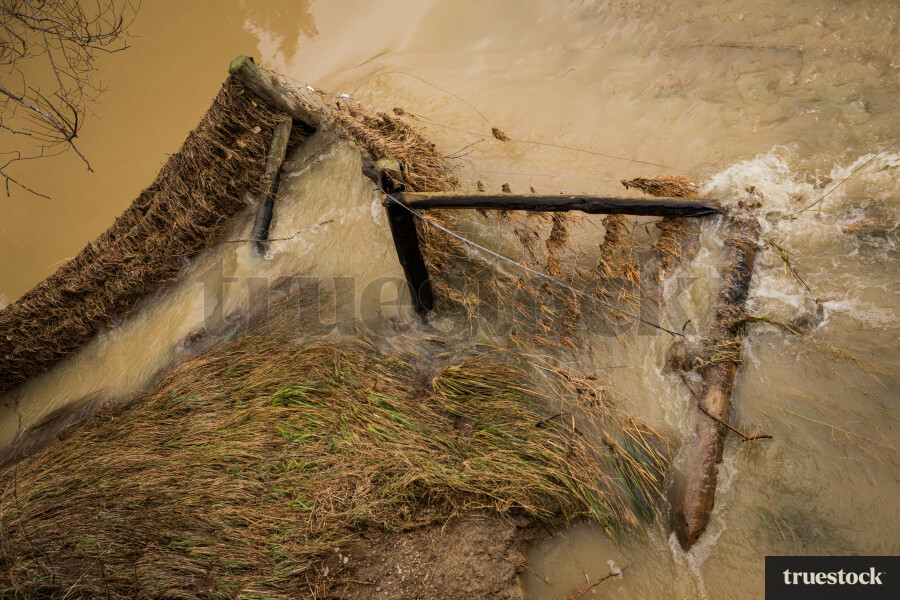 Rising river water and debris from flooding