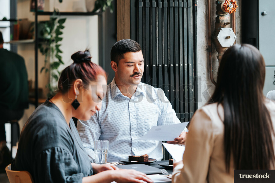 Colleagues Having a Meeting at a Cafe