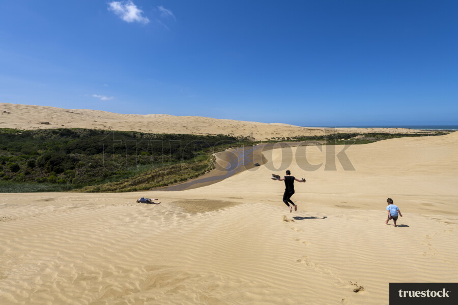 Whānau Exploring Te Paki Sand Dunes