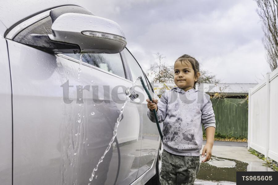 Māori boy washing car