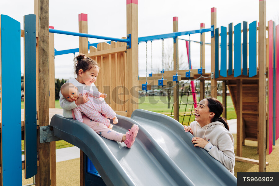 Young Girl on Slide at Park