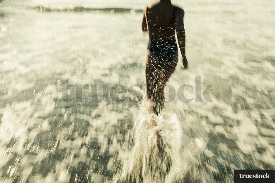 Woman Swimming at Piha Beach