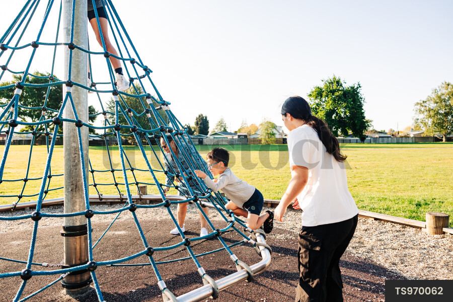 Children climbing jungle gym in park