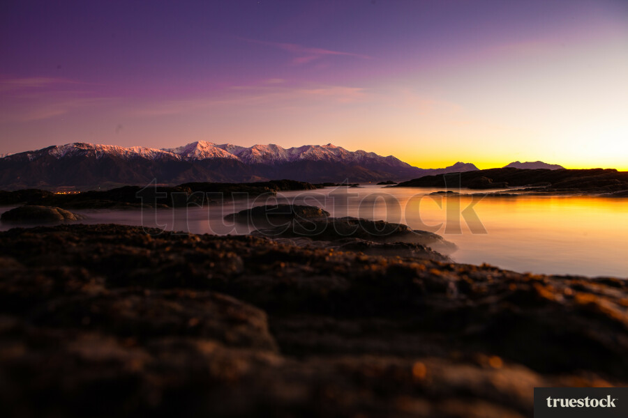 Sunset over the mountain ranges with mountain reflection