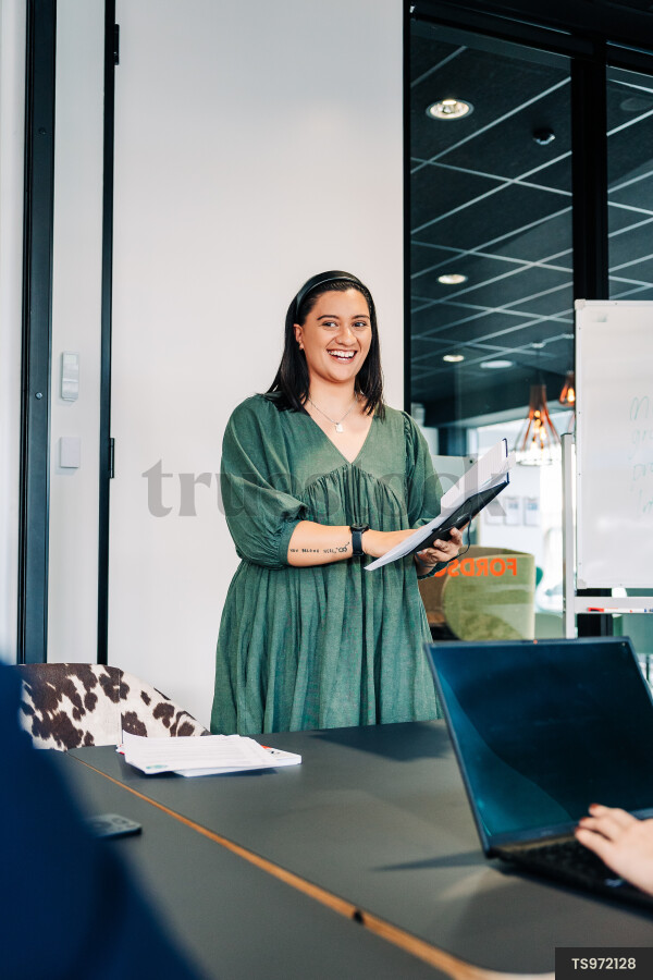 Businesswoman doing presentation during meeting in boardroom