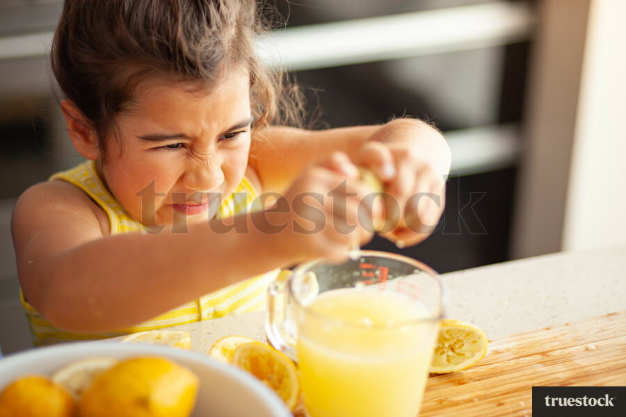 Young children making lemondade