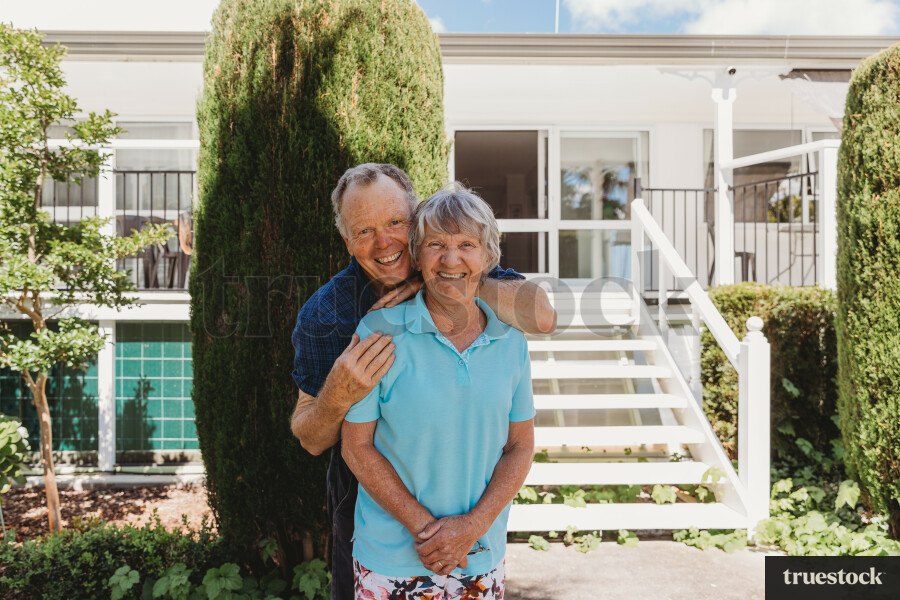 Elderly Couple Outside Their Home