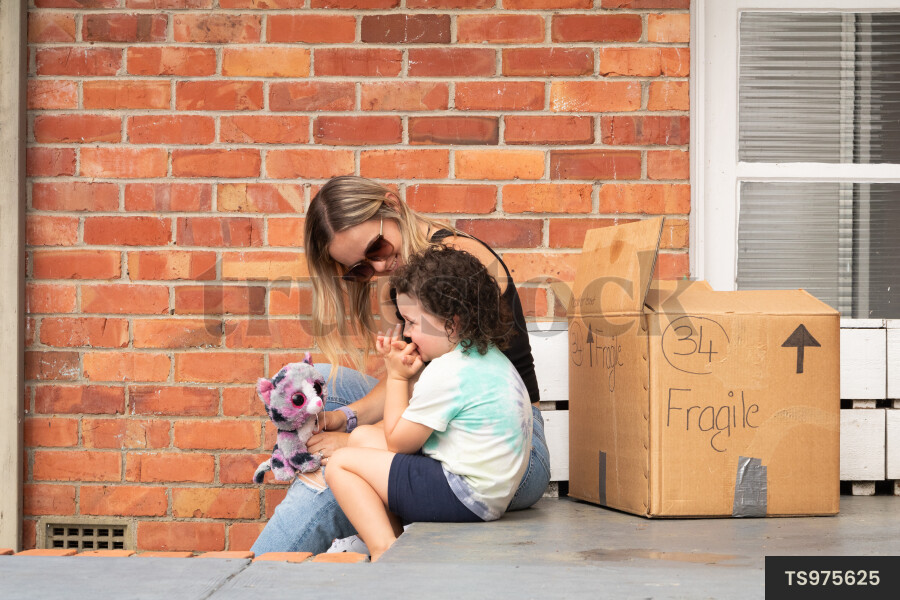 Woman and daughter sitting on patio