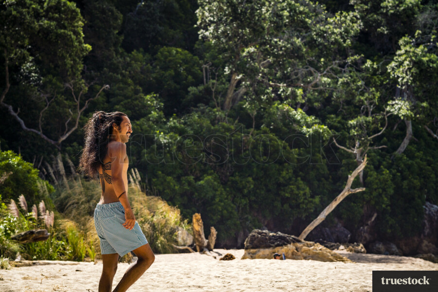 Man Walking Along Pokohino Beach
