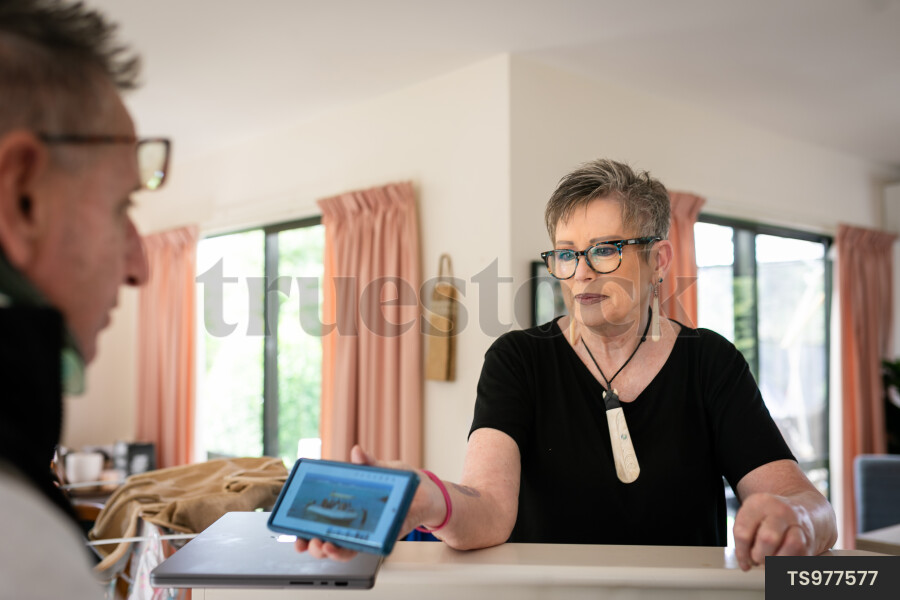 Health carer showing smart phone to patient