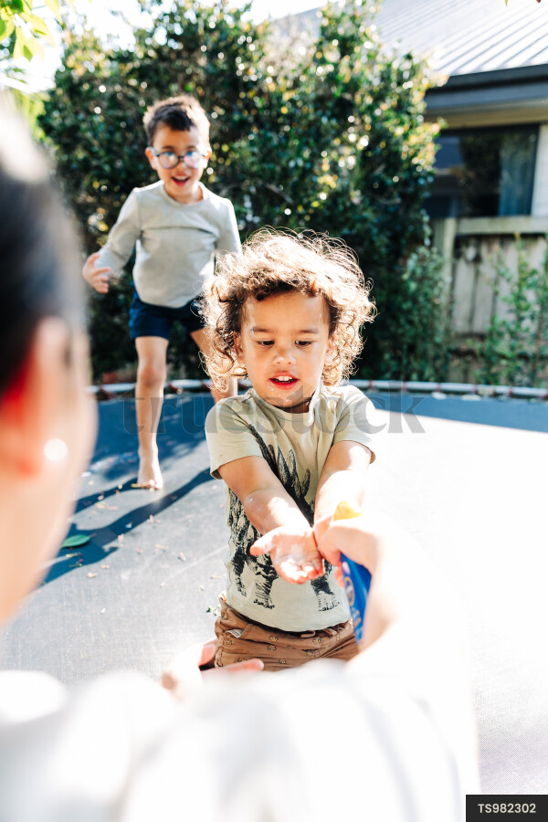 Boys playing on trampoline
