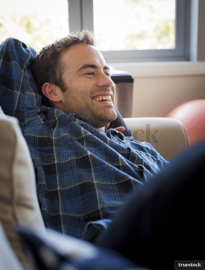 Young man lying on a sofa