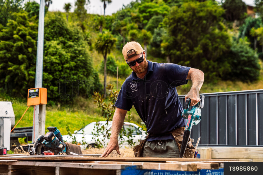 Builder Working on Wooden Fence Panel