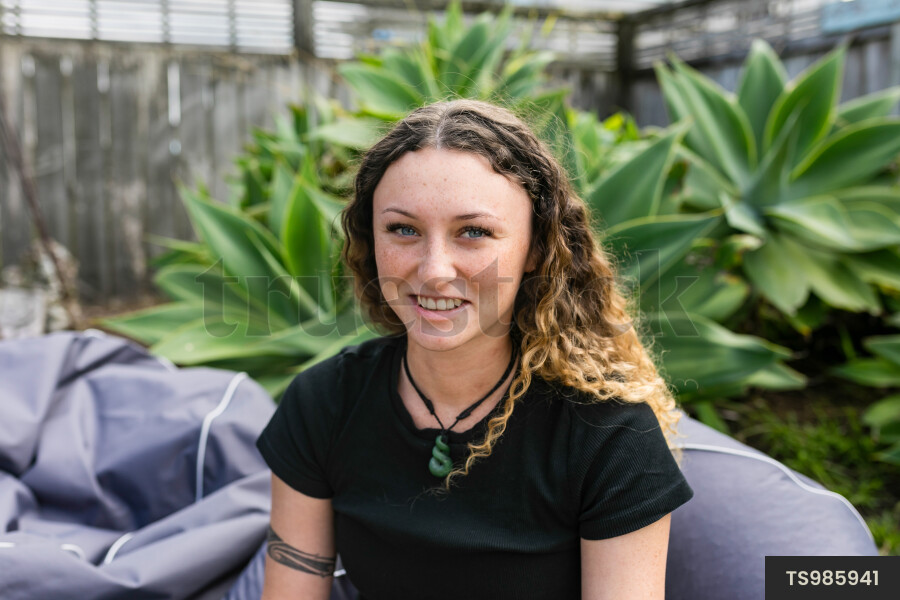 Young woman sitting in bean bag chair