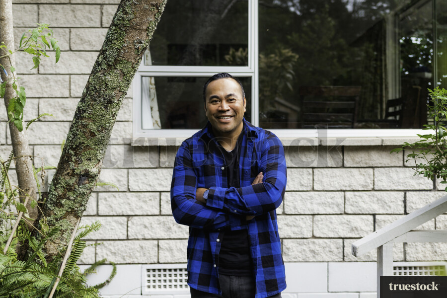 Samoan Man standing outside his Home