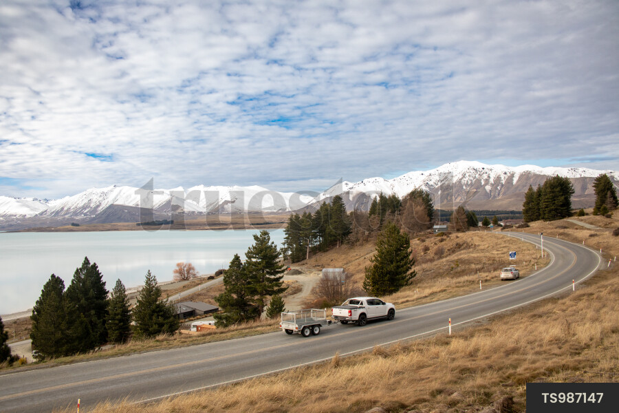 Vehicle Driving Next to Lake