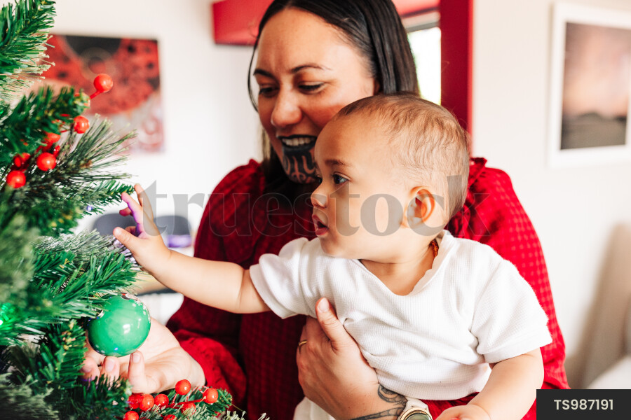 Mother and Kids Decorate Christmas Tree