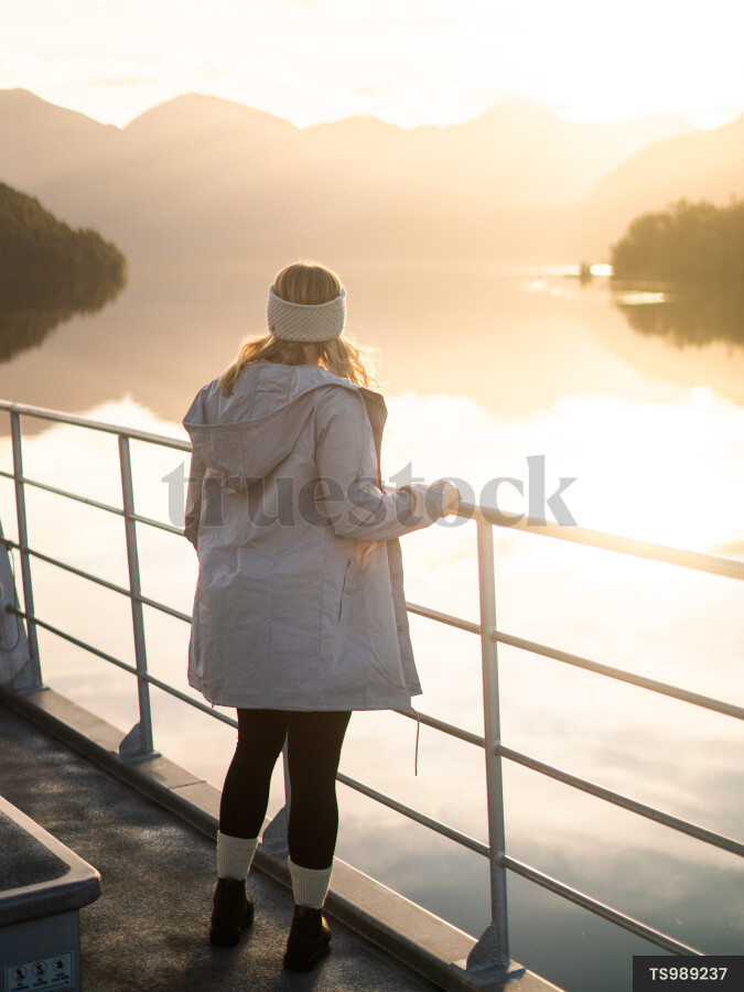 Woman on boat at sunrise